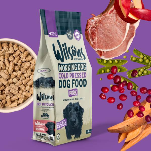 Pork Cold Pressed Working Dog Food on purple background with a bowl of cold pressed dog food and includes ingredients such as pork, sweet potato and cranberry
