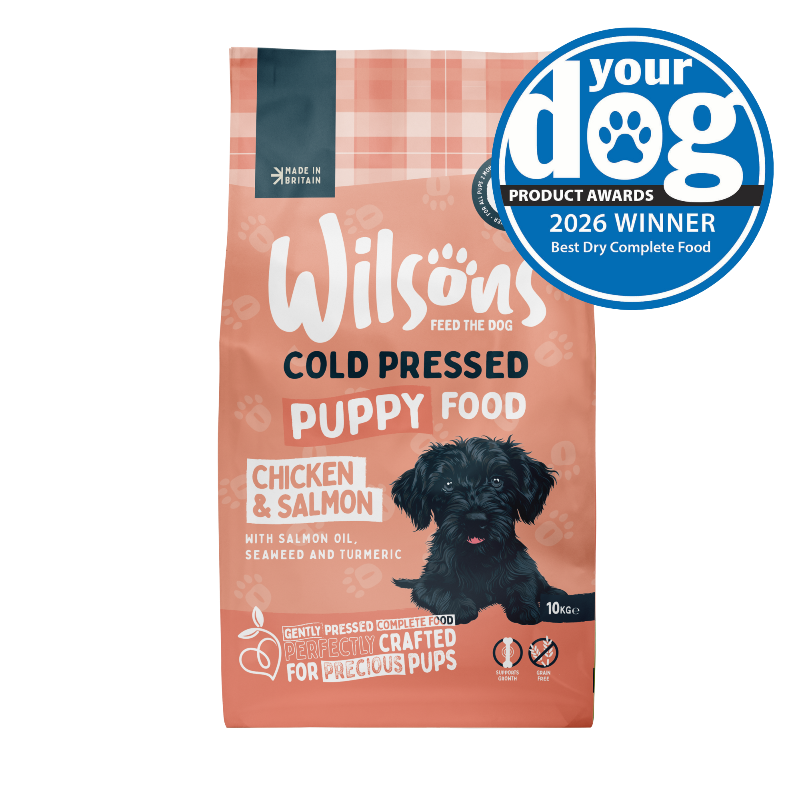 Wilsons Cold Pressed Puppy Food bag with a dog on the label and a 'Your Dog' award badge.